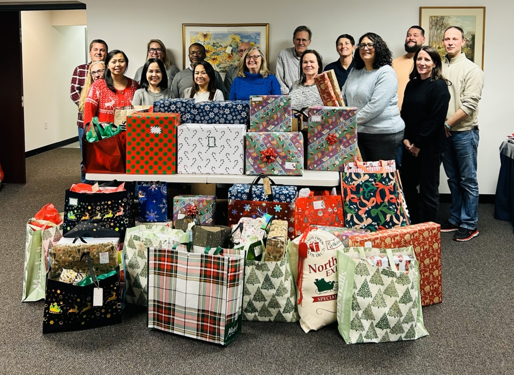 20 volunteers from Northeast Retirement Services helping SLM in Holiday Gift drive by wrapping gifts