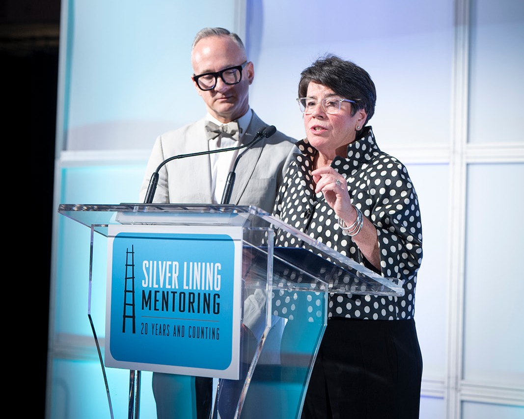 suzanne-lee-matt-marcotte-gala-co-chairs Match Gala Co-Chairs Suzanne Lee and Matt Marcotte speaking to the crowd from the stage.
